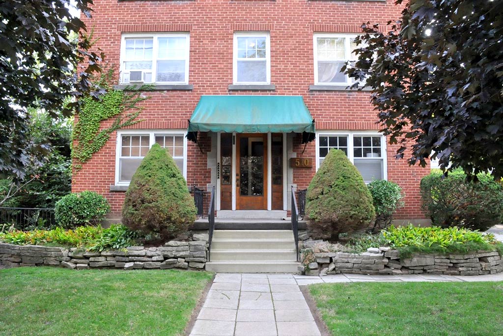 Red brick six unit fully furnished apartment rental building on Hurd Avenue in downtown Burlington